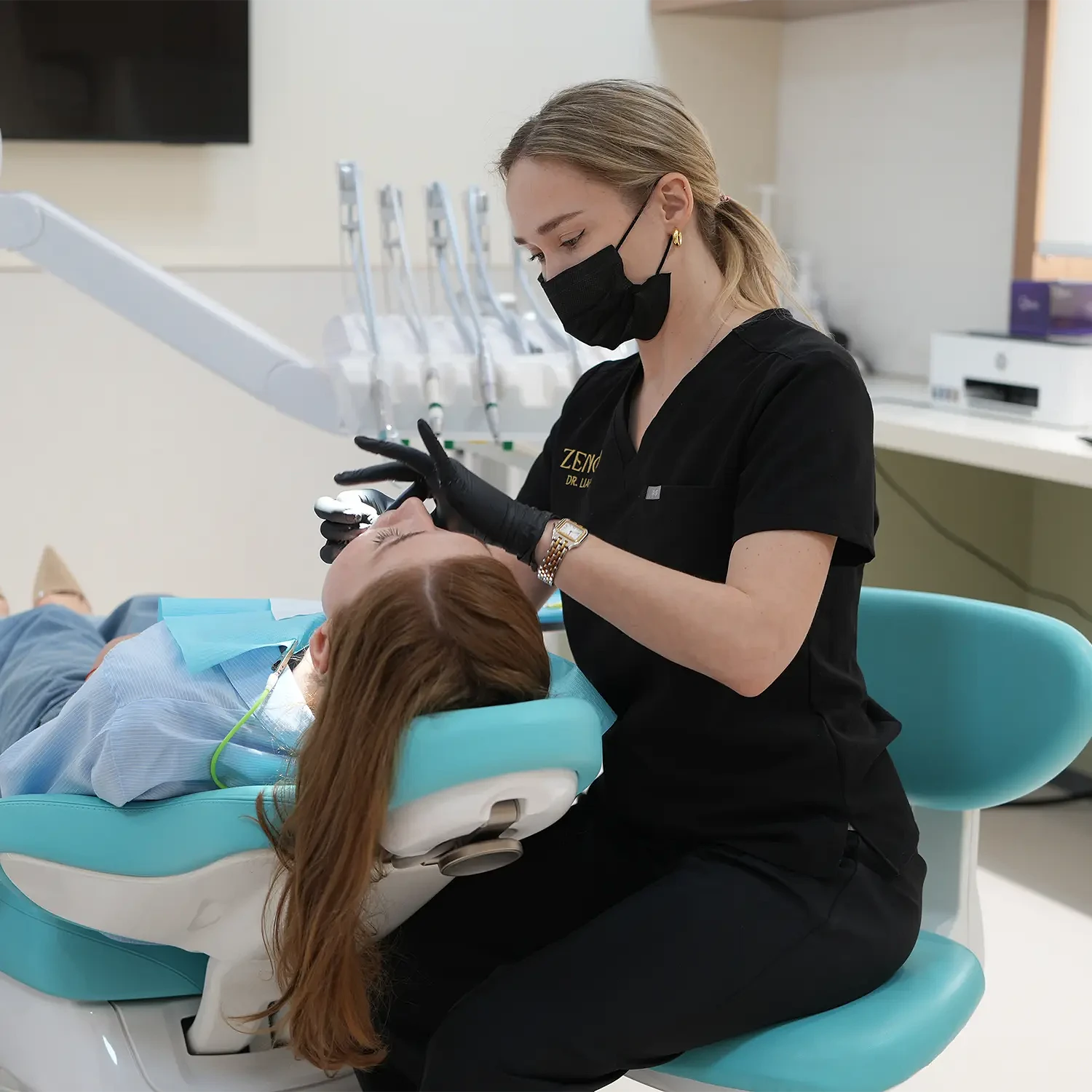 The dentist carries out a preventive procedure after fitting a crown